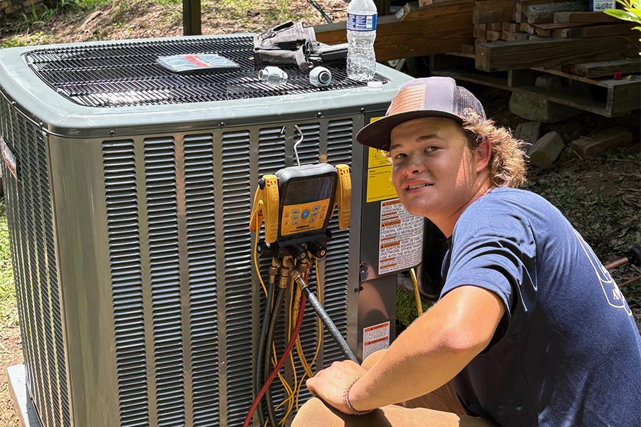 Ryan Burke with an outdoor ac unit